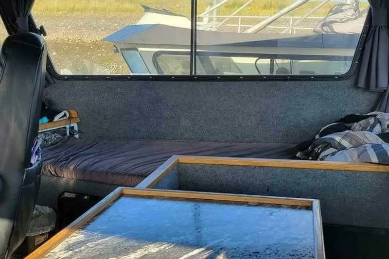 Slide: The Image of Interior of 2022 Custom Freestyle Marine 32 boat with seating and table. - 12