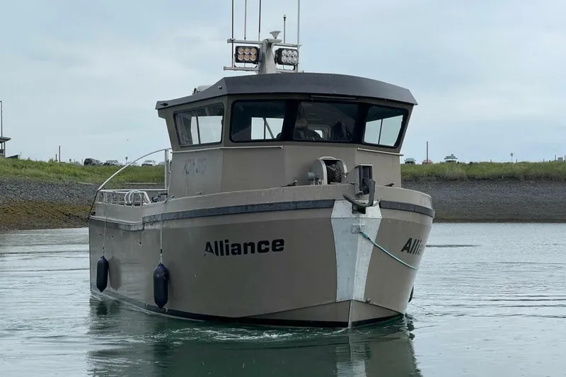 Slide: The Image of Custom Freestyle Marine 32 boat, 2022 model, named "Alliance" on calm water. - 2