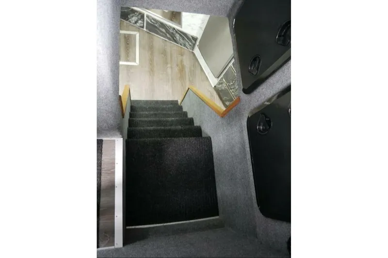 Slide: The Image of Interior stairs of 2022 Custom Freestyle Marine 32 boat, featuring carpeted steps. - 30