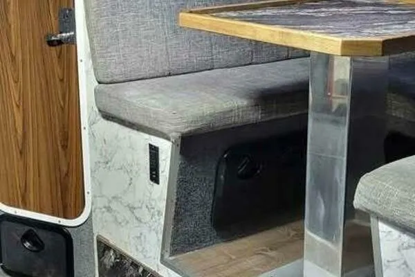 Slide: The Image of Interior of 2022 Custom Freestyle Marine 32, featuring a cozy seating area with a wooden table. - 39