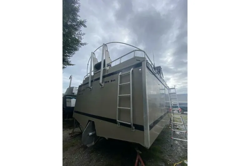 Slide: The Image of Custom Freestyle Marine 32 boat, 2022 model, with ladder and overcast sky background. - 47