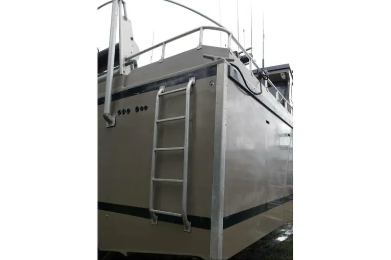 Slide: The Image of Custom Freestyle Marine 32 boat, 2022 model, featuring a sturdy ladder and sleek design. - 5