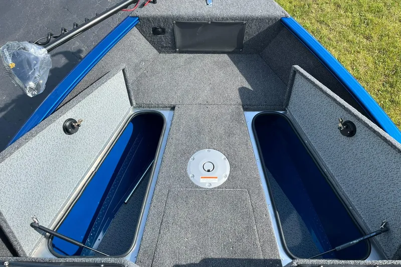 Slide: The Image of 2026 Lund 1675 Adventure Sport boat interior with open storage compartments. - 15