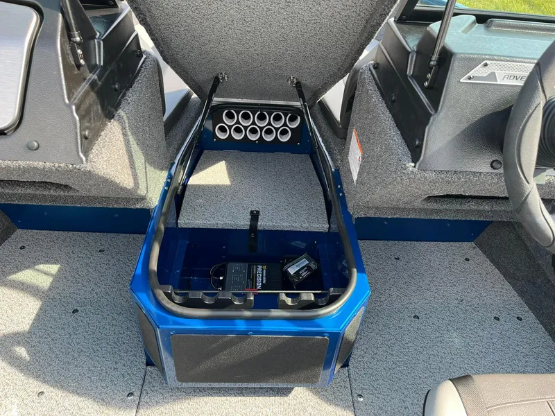 Slide: The Image of 2026 Lund 1675 Adventure Sport boat interior with open storage compartment and rod holders. - 17