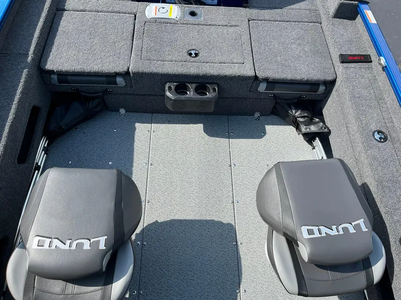 Slide: The Image of 2026 Lund 1675 Adventure Sport boat interior with gray seating and storage compartments. - 18