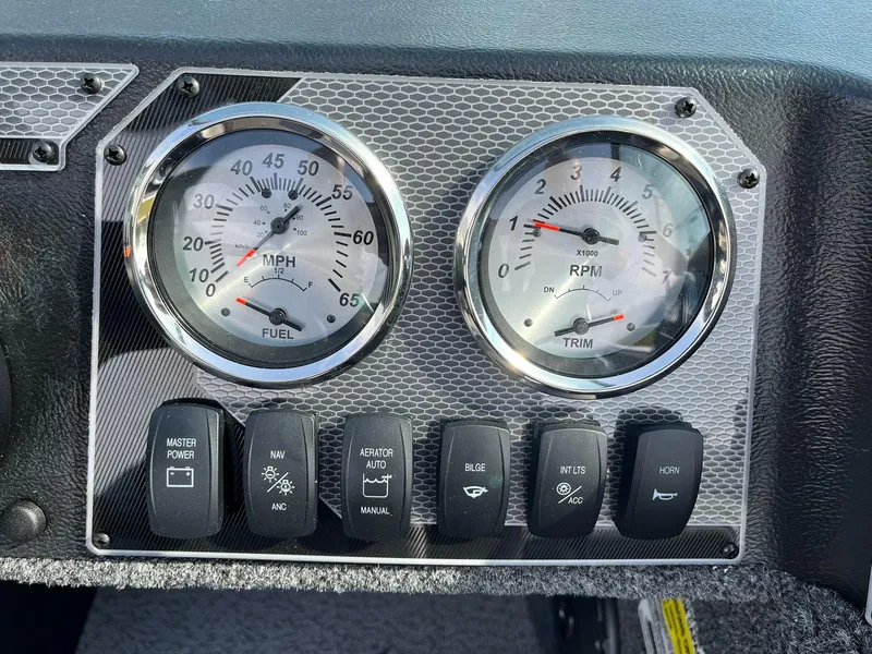 Slide: The Image of Dashboard of 2026 Lund 1675 Adventure Sport with gauges and control switches. - 22