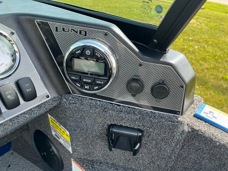 Slide: The Image of Control panel of 2026 Lund 1675 Adventure Sport boat with audio system and switches. - 23
