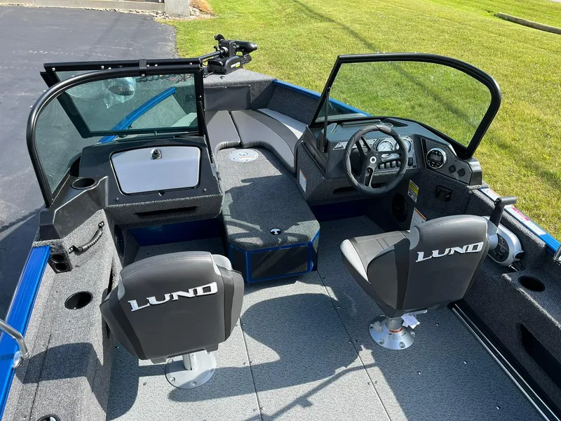 Slide: The Image of 2026 Lund 1675 Adventure Sport boat interior with steering console and seating. - 5