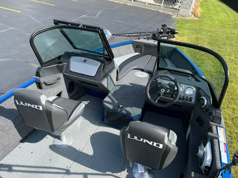 Slide: The Image of 2026 Lund 1675 Adventure Sport boat interior with dual seats and steering console. - 7