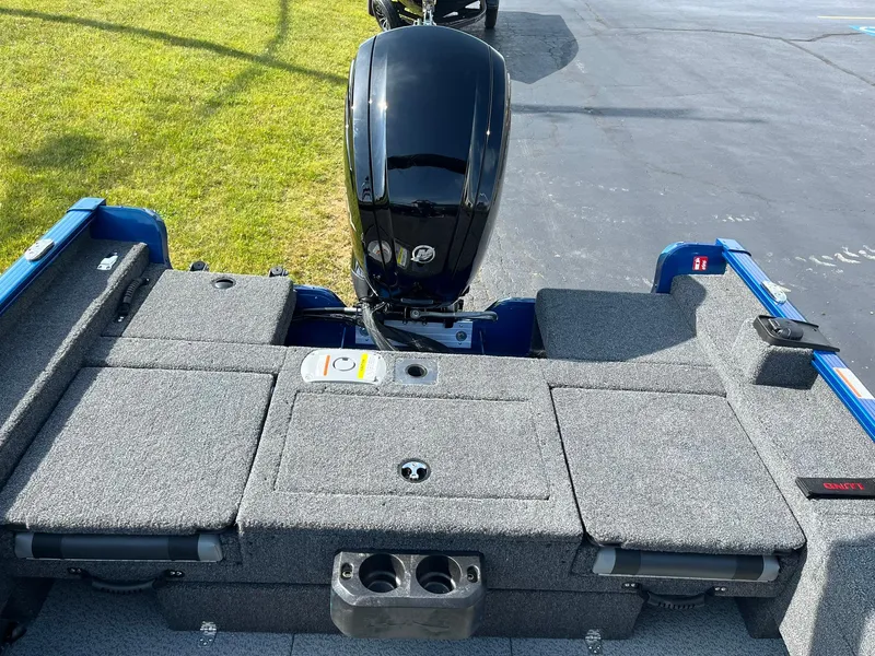 Slide: The Image of 2026 Lund 1675 Adventure Sport boat with outboard motor and carpeted deck. - 8