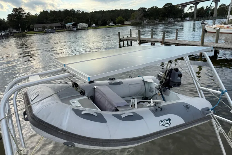 Slide: The Image of Inflatable boat with solar panel and outboard motor, docked near a Beneteau Oceanis 40 CC, 1997. - 14