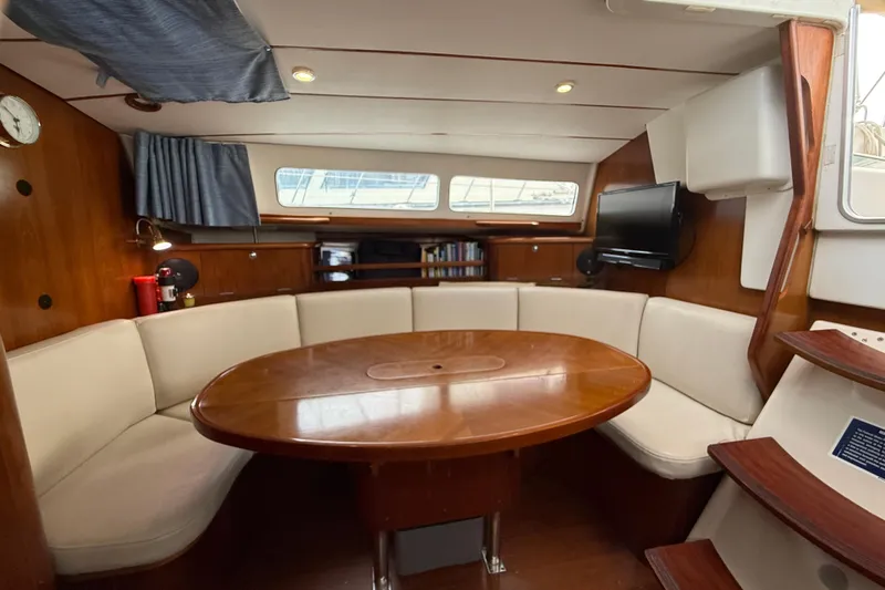 Slide: The Image of Interior of 1997 Beneteau Oceanis 40 CC yacht with cozy seating and wooden table. - 17