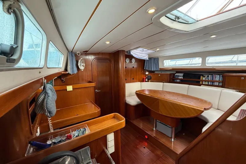 Slide: The Image of Luxurious interior of 1997 Beneteau Oceanis 40 CC sailboat with wooden furnishings and seating. - 18