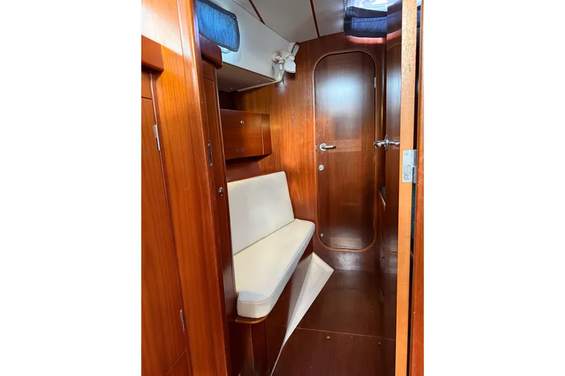 Slide: The Image of Interior of 1997 Beneteau Oceanis 40 CC sailboat with wooden finish and seating area. - 19