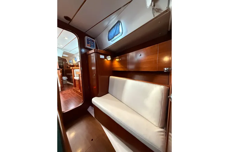 Slide: The Image of Interior of 1997 Beneteau Oceanis 40 CC sailboat with wooden cabinetry and cushioned seating. - 20