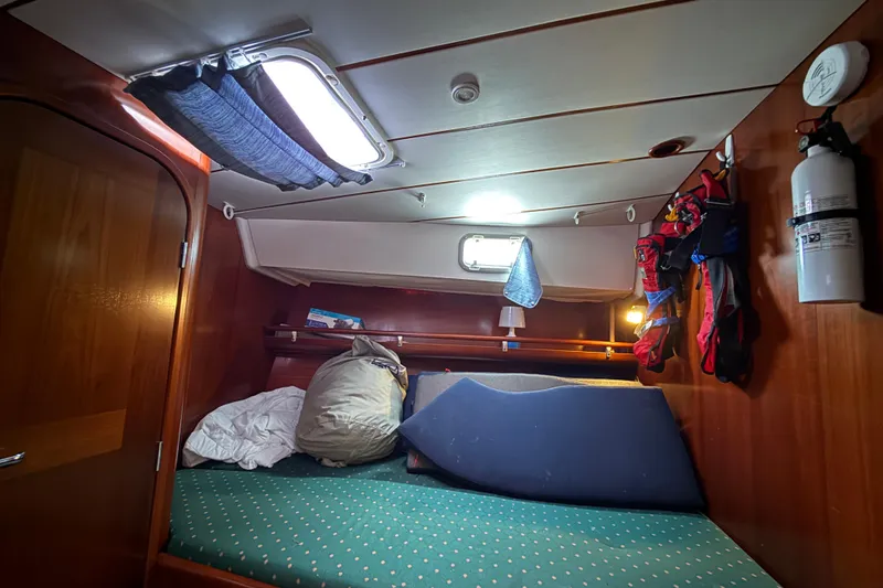 Slide: The Image of Cozy cabin interior of 1997 Beneteau Oceanis 40 CC sailboat with bedding and storage. - 21