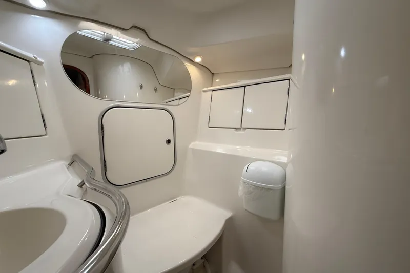 Slide: The Image of Bathroom interior of 1997 Beneteau Oceanis 40 CC yacht, featuring sleek white design. - 23