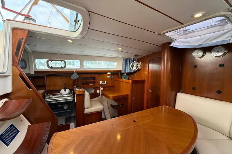 Slide: The Image of Interior of 1997 Beneteau Oceanis 40 CC sailboat with wood finish and dining area. - 25