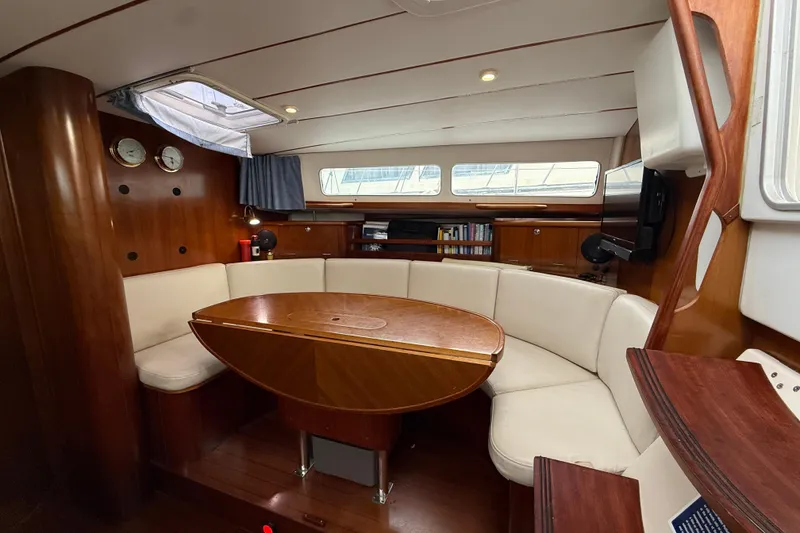 Slide: The Image of Interior of 1997 Beneteau Oceanis 40 CC sailboat with wood finish and curved seating. - 27