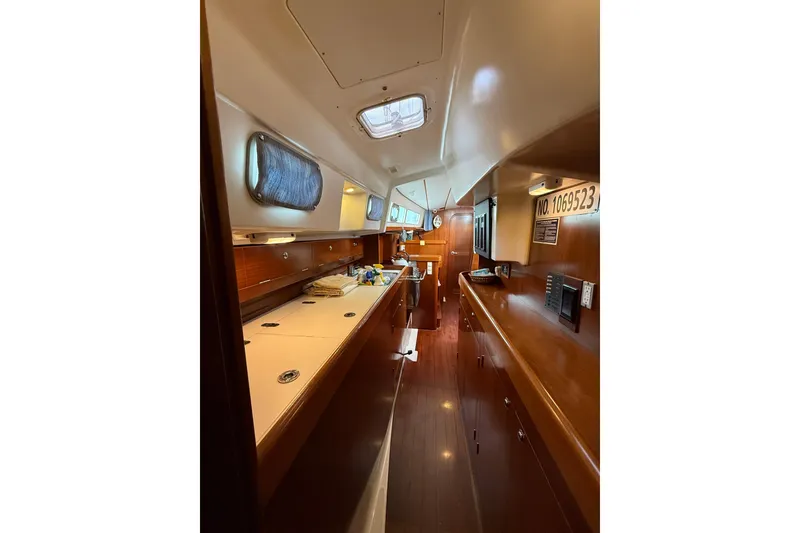 Slide: The Image of Interior of 1997 Beneteau Oceanis 40 CC sailboat, featuring wood finishes and compact design. - 28