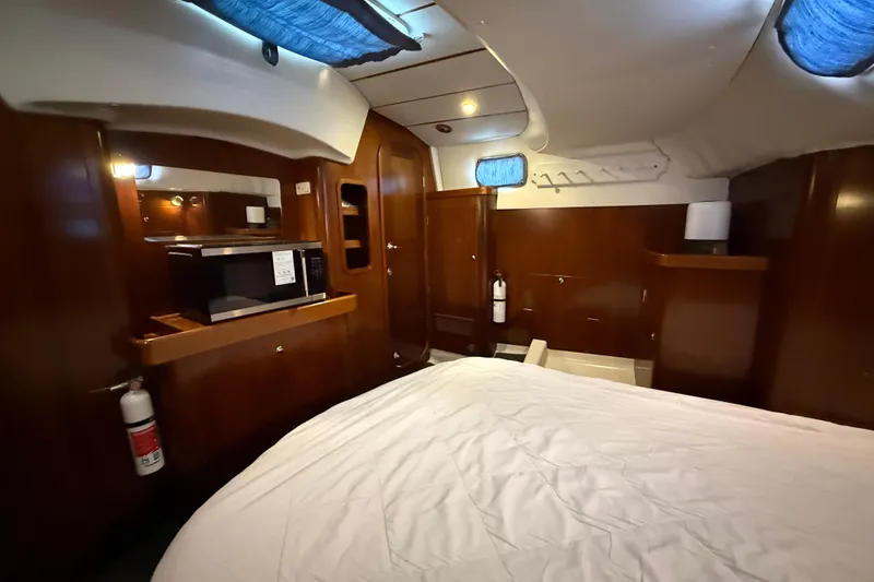 Slide: The Image of Interior of 1997 Beneteau Oceanis 40 CC yacht with wood paneling and bed. - 31