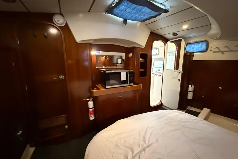 Slide: The Image of Interior of 1997 Beneteau Oceanis 40 CC yacht with wood finish and modern amenities. - 33