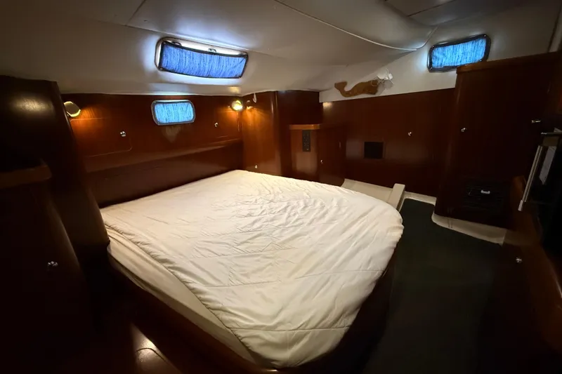 Slide: The Image of Cozy cabin interior of 1997 Beneteau Oceanis 40 CC with wood paneling and bed. - 34