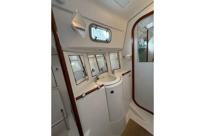 Slide: The Image of Bathroom interior of 1997 Beneteau Oceanis 40 CC yacht, featuring sink and mirrors. - 36