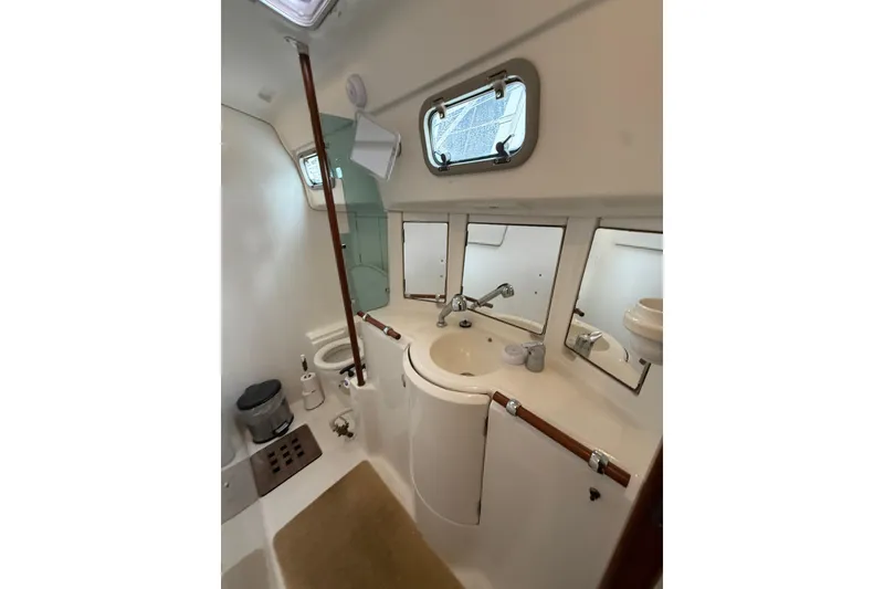 Slide: The Image of Bathroom interior of 1997 Beneteau Oceanis 40 CC yacht, featuring sink and mirrors. - 37