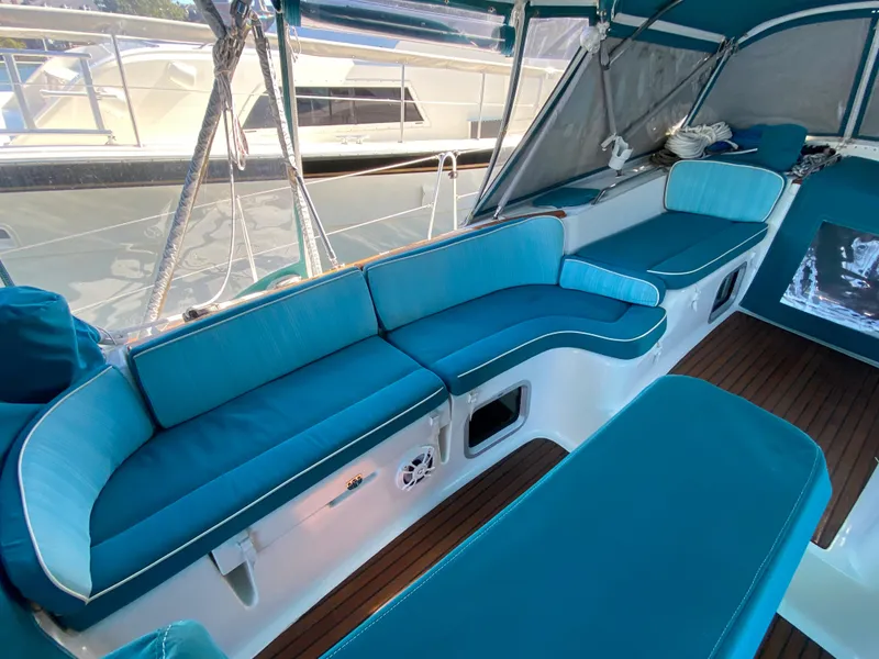 Slide: The Image of Luxurious seating area on 2008 Jeanneau Sun Odyssey 54 DS yacht with teal cushions. - 19
