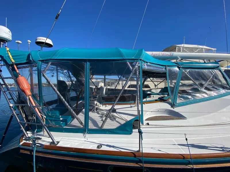 Slide: The Image of Jeanneau Sun Odyssey 54 DS 2008 sailboat with teal canopy in marina. - 2