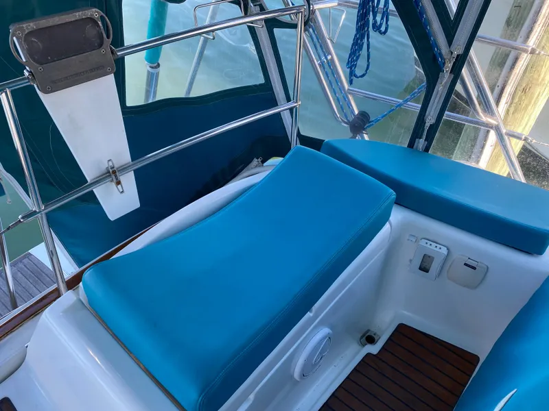 Slide: The Image of Jeanneau Sun Odyssey 54 DS 2008 cockpit with blue cushions and teak flooring. - 26