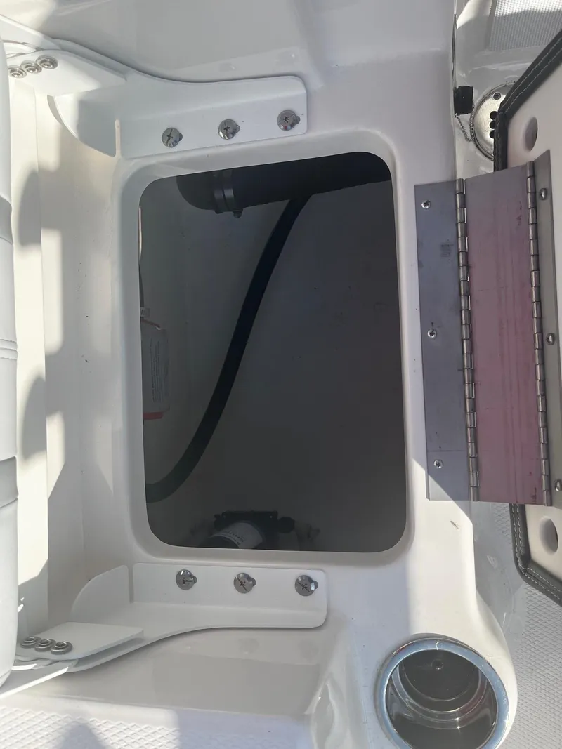 Slide: The Image of 2025 Robalo R180 Center Console storage compartment with open hatch. - 13