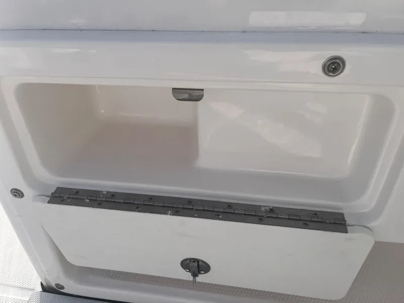 Slide: The Image of 2025 Robalo R180 Center Console storage compartment, open and empty. - 4