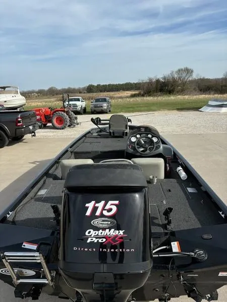 Slide: The Image of Minn Kota Maxxum motor on 2012 Lowe Stinger 18 HP boat, parked outdoors. - 2