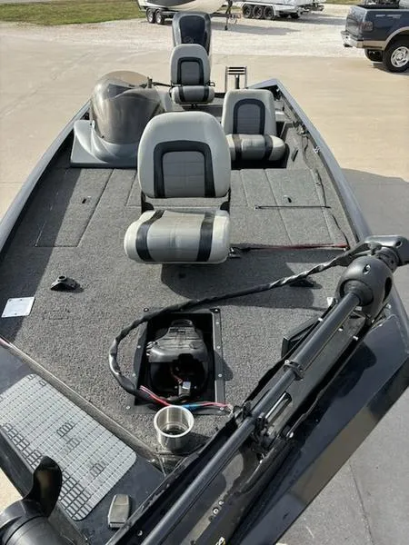 Slide: The Image of 2012 Lowe Stinger 18 HP boat on trailer, parked outdoors under clear sky. - 3