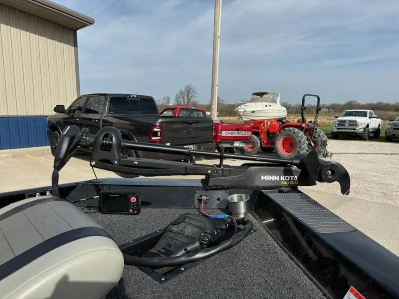 Slide: The Image of 2012 Lowe Stinger 18 HP boat with 115 OptiMax Pro motor, parked outdoors. - 4