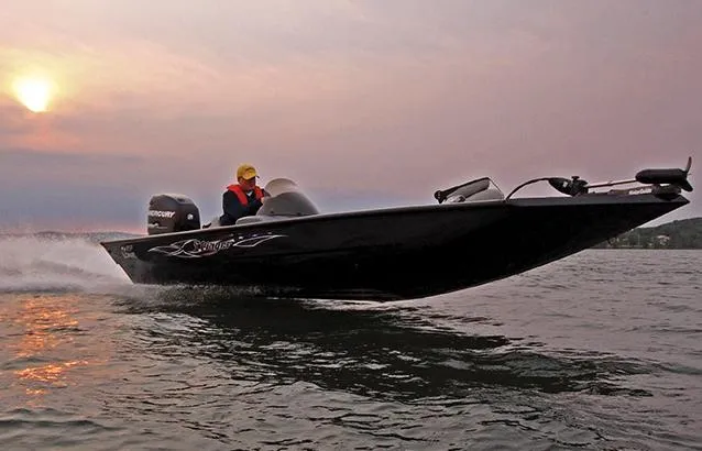 Slide: The Image of 2012 Lowe Stinger 18 HP boat interior with seating and steering console. - 9