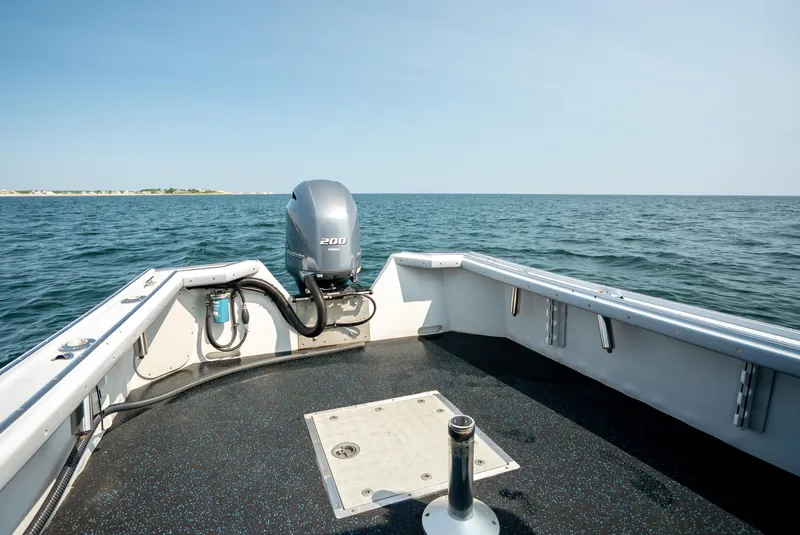 Slide: The Image of Calvin Beal 25 Custom boat, 2021 model, on open water with clear skies. - 12