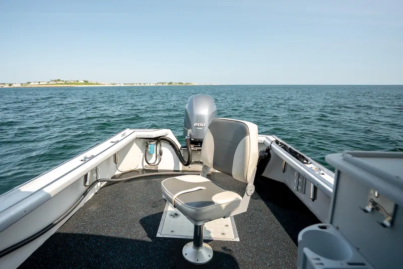 Slide: The Image of 2021 Beal Calvin Beal 25 Custom boat on open water, featuring a central seat and outboard motor. - 13