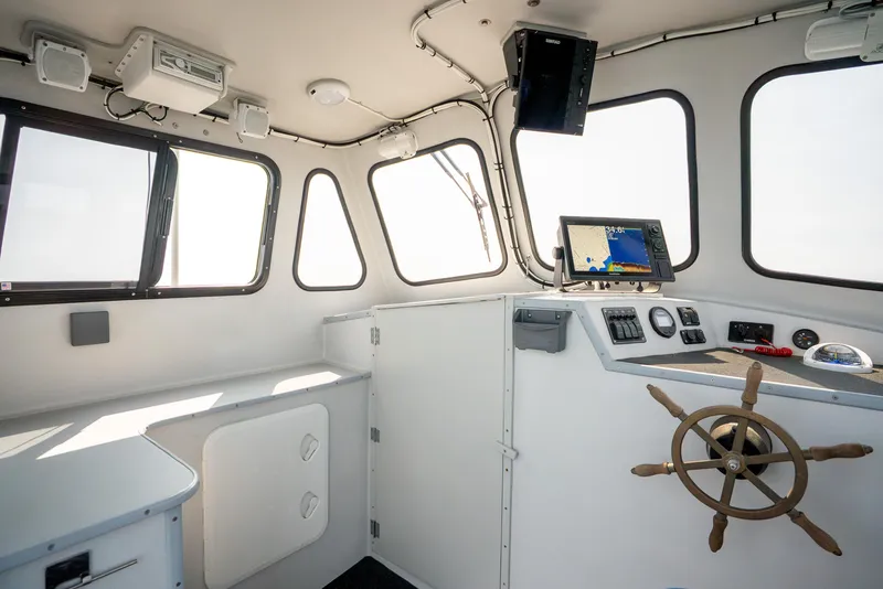 Slide: The Image of Interior of 2021 Beal Calvin Beal 25 Custom boat with navigation equipment and steering wheel. - 20