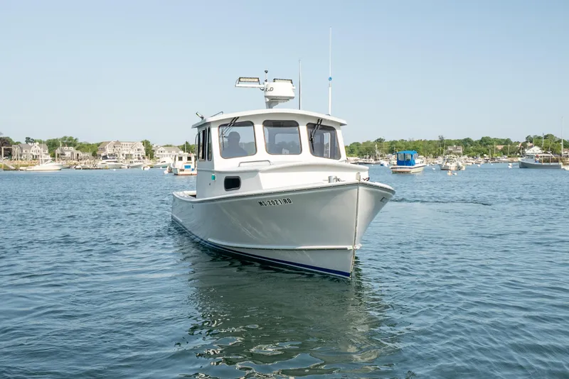 Slide: The Image of 2021 Beal Calvin Beal 25 Custom boat on calm water, with coastal background. - 8
