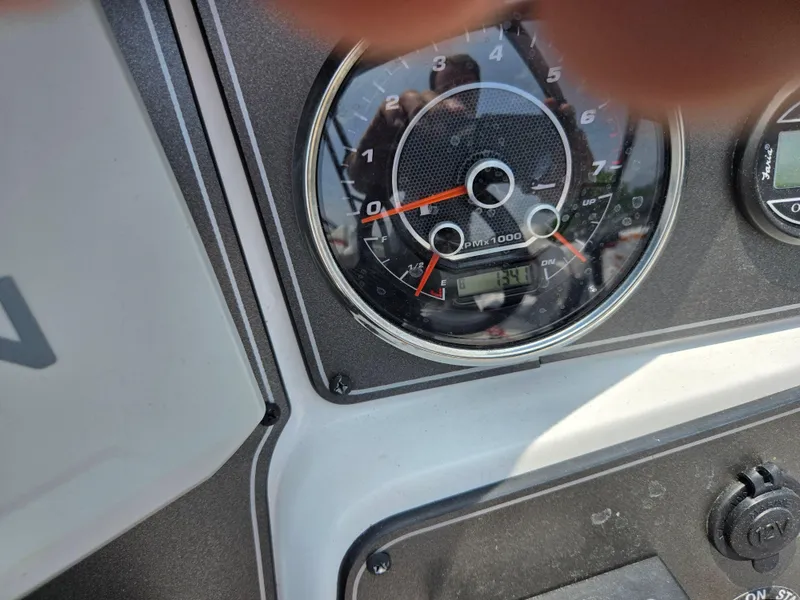 Slide: The Image of Dashboard of 2021 Hurricane SunDeck 217 OB boat with tachometer and controls. - 15