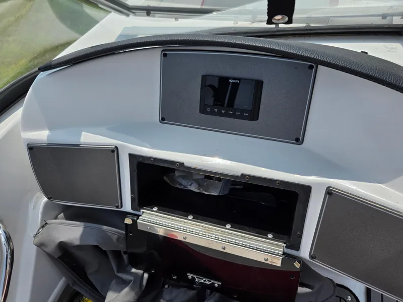 Slide: The Image of Dashboard of 2021 Hurricane SunDeck 217 OB boat with control panel and storage compartments. - 16