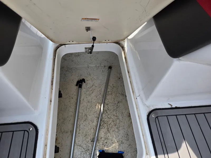 Slide: The Image of Storage compartment of 2021 Hurricane SunDeck 217 OB boat with equipment inside. - 17