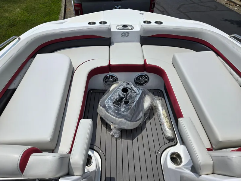 Slide: The Image of 2021 Hurricane SunDeck 217 OB boat interior with white and red seating and cup holders. - 18