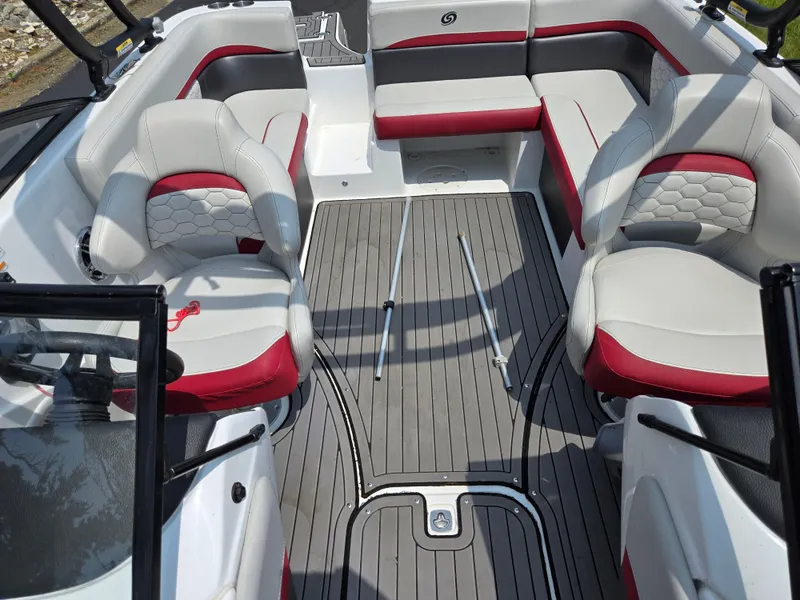 Slide: The Image of 2021 Hurricane SunDeck 217 OB interior with red and gray seating, spacious layout. - 22