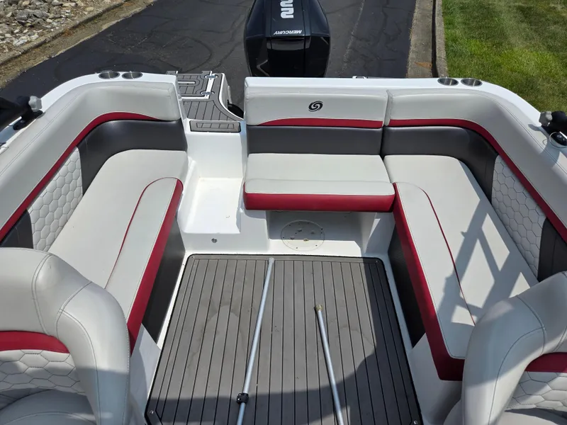 Slide: The Image of 2021 Hurricane SunDeck 217 OB boat interior with gray and red seating, spacious layout. - 23