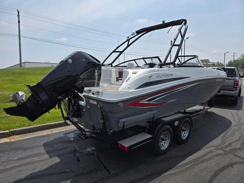 Slide: The Image of 2021 Hurricane SunDeck 217 OB boat on trailer, featuring sleek design and powerful outboard motor. - 3
