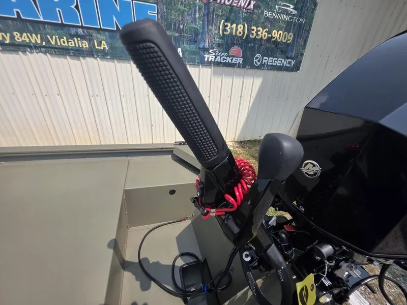 Slide: The Image of 2025 Tracker Grizzly 1648 Utility boat controls with throttle and steering handle. - 8